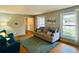 A cozy living room features hardwood floors, bright windows, and neutral-colored furniture at 6918 E Easter Pl, Centennial, CO 80112