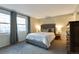 Serene main bedroom with a plush bed, large windows, and soft, neutral tones at 6918 E Easter Pl, Centennial, CO 80112