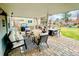 Stylish covered patio featuring brick pavers, comfortable seating, and dining area at 6918 E Easter Pl, Centennial, CO 80112