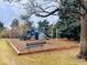 Community playground with swings, slides, and climbing structures, surrounded by woodchips at 6918 E Easter Pl, Centennial, CO 80112