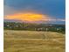 Scenic sunset view overlooking a neighborhood with mountains in the distance at 6918 E Easter Pl, Centennial, CO 80112