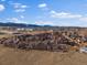 Wide aerial captures a community with mountain backdrop and manicured landscaping at 9962 W Victoria Pl # 106, Littleton, CO 80127