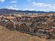 Expansive aerial view showcases a community with mountain backdrop and manicured grounds at 9962 W Victoria Pl # 106, Littleton, CO 80127