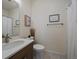 Well-lit bathroom with a modern vanity, decorative accents, and a shower with a curtain at 9962 W Victoria Pl # 106, Littleton, CO 80127