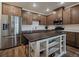 Beautiful kitchen with white countertops, stainless steel appliances, and a dark wood island at 9962 W Victoria Pl # 106, Littleton, CO 80127