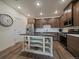 Contemporary kitchen with white countertops, stainless steel appliances, and a dark wood island at 9962 W Victoria Pl # 106, Littleton, CO 80127