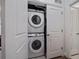 Convenient laundry closet featuring a stacked washer and dryer unit, maximizing space efficiency at 9962 W Victoria Pl # 106, Littleton, CO 80127