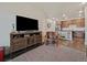 Open concept living room flows to the kitchen featuring wood floors, tv, and armchair at 9962 W Victoria Pl # 106, Littleton, CO 80127