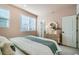 Bright bedroom with a comfortable bed, decorative mirror, and ample natural light from large windows at 16555 Peak Way, Broomfield, CO 80023