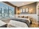 Inviting bedroom featuring a cozy bed, modern decor, and large window with natural light at 16555 Peak Way, Broomfield, CO 80023