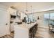 Modern kitchen with white cabinets, stainless steel appliances, and seating at the island at 16555 Peak Way, Broomfield, CO 80023
