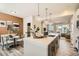 Open-concept kitchen featuring a large island, modern lighting, and dining area at 16555 Peak Way, Broomfield, CO 80023