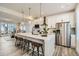 Modern kitchen boasts a large island, stainless steel appliances, and an open concept layout, ideal for entertaining at 16555 Peak Way, Broomfield, CO 80023