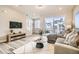Inviting living room with balcony access, stylish decor, and comfortable seating for relaxation at 16555 Peak Way, Broomfield, CO 80023