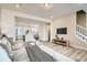 Spacious open-concept living area with modern decor, hardwood floors, and seamless flow to kitchen at 16555 Peak Way, Broomfield, CO 80023