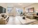 Bright living room with a sliding door to a balcony, showcasing modern design and comfortable furnishings at 16555 Peak Way, Broomfield, CO 80023