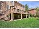 Spacious backyard with a covered patio and a raised deck perfect for entertaining at 7420 S Wolff St, Littleton, CO 80128
