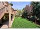 Beautifully landscaped backyard with a well-maintained lawn and mature trees at 7420 S Wolff St, Littleton, CO 80128
