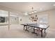 Spacious basement featuring recessed lighting, neutral walls, and a ping pong table near the windows at 7420 S Wolff St, Littleton, CO 80128