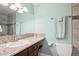 Neutral-toned bathroom featuring a granite-topped vanity, a mirrored wall, a toilet, and tiled floors at 7420 S Wolff St, Littleton, CO 80128