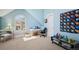 Bright blue bedroom with a white desk, a window, and an area rug over neutral carpet at 7420 S Wolff St, Littleton, CO 80128