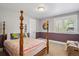 Bright bedroom with a four poster bed, two toned walls, and a window with plantation shutters at 7420 S Wolff St, Littleton, CO 80128