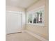 Neutral bedroom featuring carpet, a closet with sliding doors, and a window with shutters at 7420 S Wolff St, Littleton, CO 80128