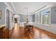 Spacious dining room with hardwood floors, large windows, and elegant chandelier at 7420 S Wolff St, Littleton, CO 80128