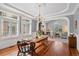 This dining room features hardwood floors, large windows, and detailed crown molding at 7420 S Wolff St, Littleton, CO 80128