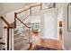 Open foyer with wood floors, stairs, and natural light filtering into the living room at 7420 S Wolff St, Littleton, CO 80128