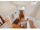 Bright foyer with a wooden front door, chandelier, hardwood floors, staircase and views to other living areas at 7420 S Wolff St, Littleton, CO 80128