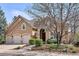Charming home featuring a three-car garage, stone accents, and a landscaped front yard at 7420 S Wolff St, Littleton, CO 80128