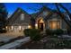 Charming home featuring a three-car garage, stone accents, and a manicured front yard at 7420 S Wolff St, Littleton, CO 80128