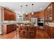 An eat-in kitchen boasts wooden cabinets, stainless appliances, and granite countertops at 7420 S Wolff St, Littleton, CO 80128