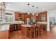An eat-in kitchen boasts wooden cabinets, stainless appliances, and granite countertops at 7420 S Wolff St, Littleton, CO 80128