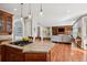 A kitchen island provides seating and a cooktop in this open-concept layout at 7420 S Wolff St, Littleton, CO 80128