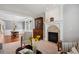 Cozy living room with fireplace, large windows, and elegant furniture looking into the dining room at 7420 S Wolff St, Littleton, CO 80128