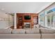 A comfortable living room features built-in bookshelves, a fireplace, and large windows at 7420 S Wolff St, Littleton, CO 80128