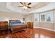 Spacious main bedroom featuring hardwood floors, tray ceilings, plantation shutters, and generous natural light at 7420 S Wolff St, Littleton, CO 80128