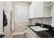 The mudroom offers white cabinets, a sink, and a convenient place to hang coats at 7420 S Wolff St, Littleton, CO 80128