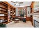 This home office has built-in bookshelves, wood trim, and ample natural light at 7420 S Wolff St, Littleton, CO 80128