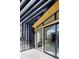A spacious balcony featuring sleek glass railings, sliding glass doors, and stylish black frame at 4815 W 10Th Ave, Denver, CO 80204