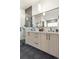 Bright bathroom showcasing double sinks, modern vanity, glass enclosed shower, and unique floor tiles at 4815 W 10Th Ave, Denver, CO 80204