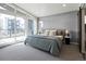 A light filled bedroom has floor to ceiling windows and balcony access with stylish modern furniture at 4815 W 10Th Ave, Denver, CO 80204