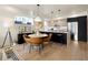 A gourmet kitchen and breakfast nook has stainless steel appliances, pendant lights and modern accents at 4815 W 10Th Ave, Denver, CO 80204