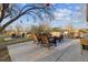 Relaxing outdoor patio with comfortable wicker seating, rug, and backyard with tree at 12023 W Virginia Ave, Lakewood, CO 80228