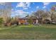 Spacious backyard with well-maintained lawn and a charming brick home exterior at 12023 W Virginia Ave, Lakewood, CO 80228