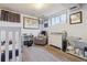 Bright Bedroom room, featuring neutral gray tones, a crib, rocking chair, and changing table at 12023 W Virginia Ave, Lakewood, CO 80228