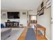 Inviting entryway featuring hardwood floors, with a view of the dining area and an open floorplan at 12023 W Virginia Ave, Lakewood, CO 80228