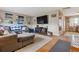Cozy living room with hardwood floors, a comfortable sectional sofa, and natural light at 12023 W Virginia Ave, Lakewood, CO 80228
